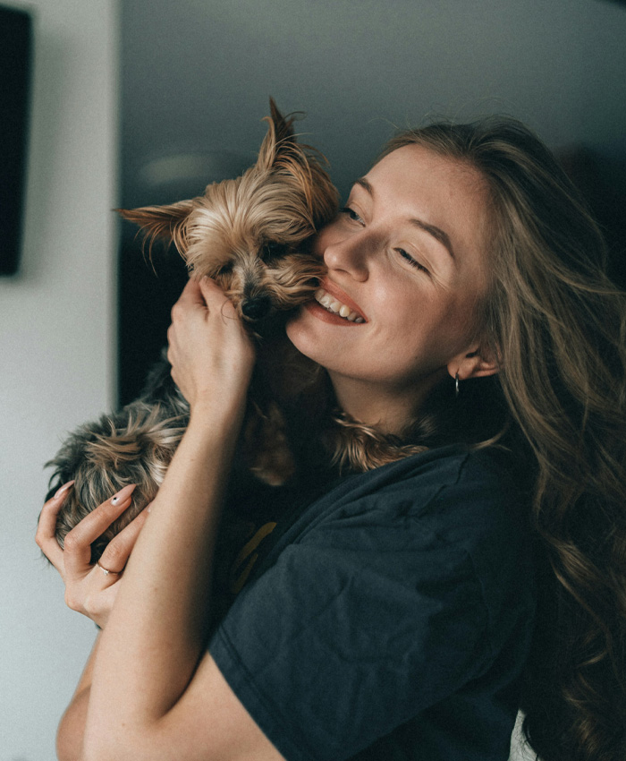 woman holding a yorkie dog