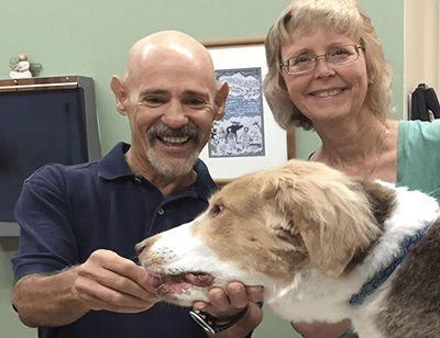 Happy couple and their pet dog
